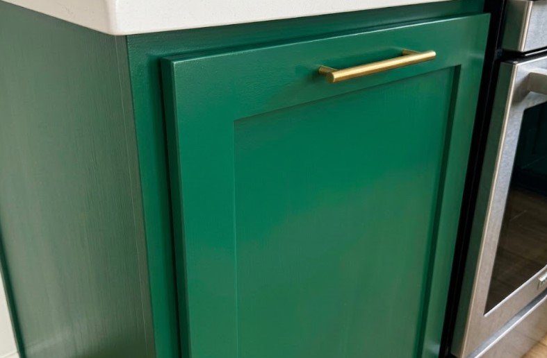 Why Is My Paint Chipping? Poor Prep or Surface Used to Soon? 4 The same green cabinet door with a smooth, even enamel finish and clean edges