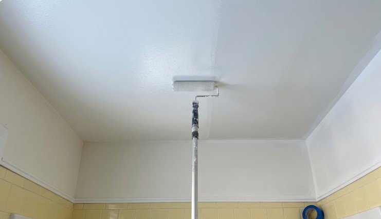 Bathroom ceiling after peeling paint was removed, primed, and repainted