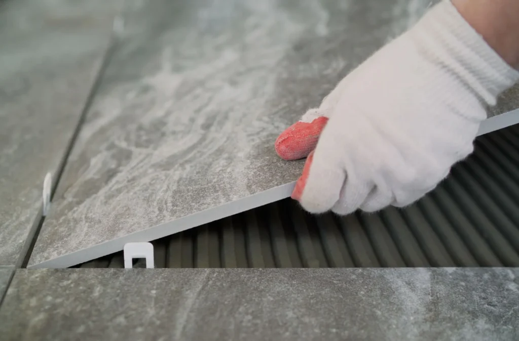 Common Tile Installation Mistakes to Avoid in Sterling Heights 7 a person using a tile on a floor