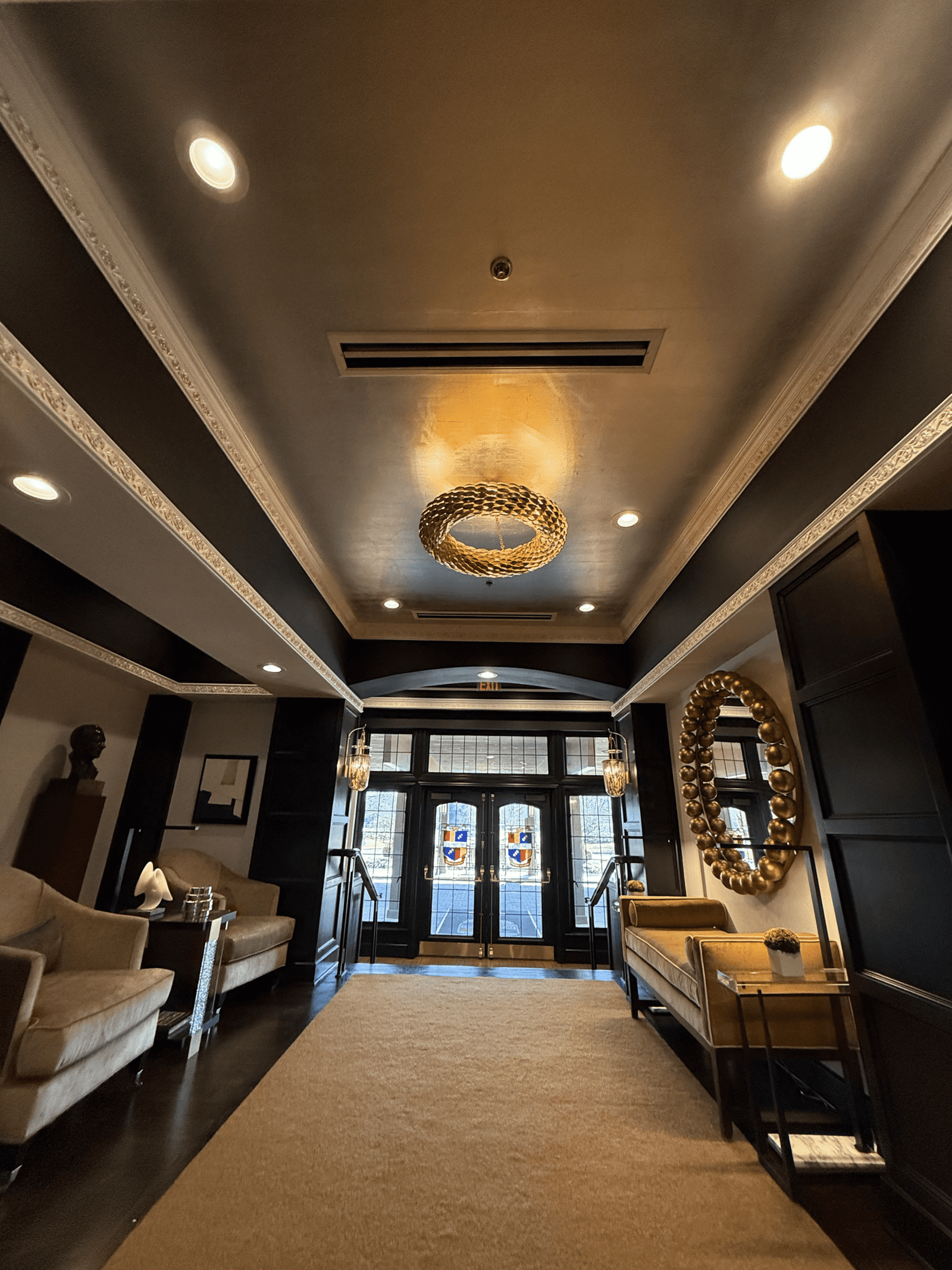 a hallway with a couch and a mirror