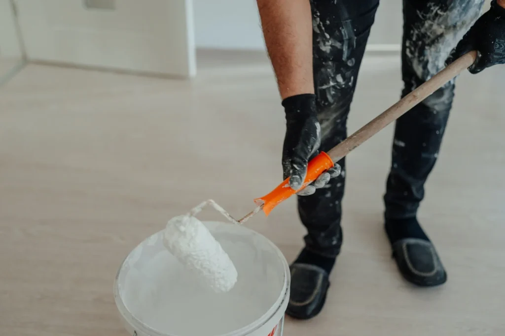 a person holding a paint roller
