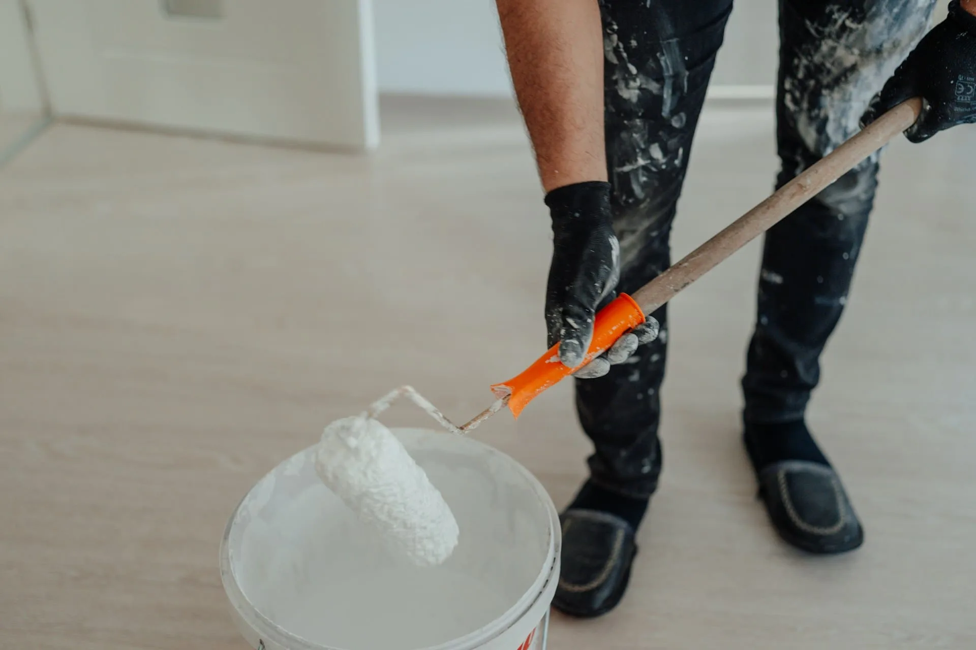 a person holding a paint roller