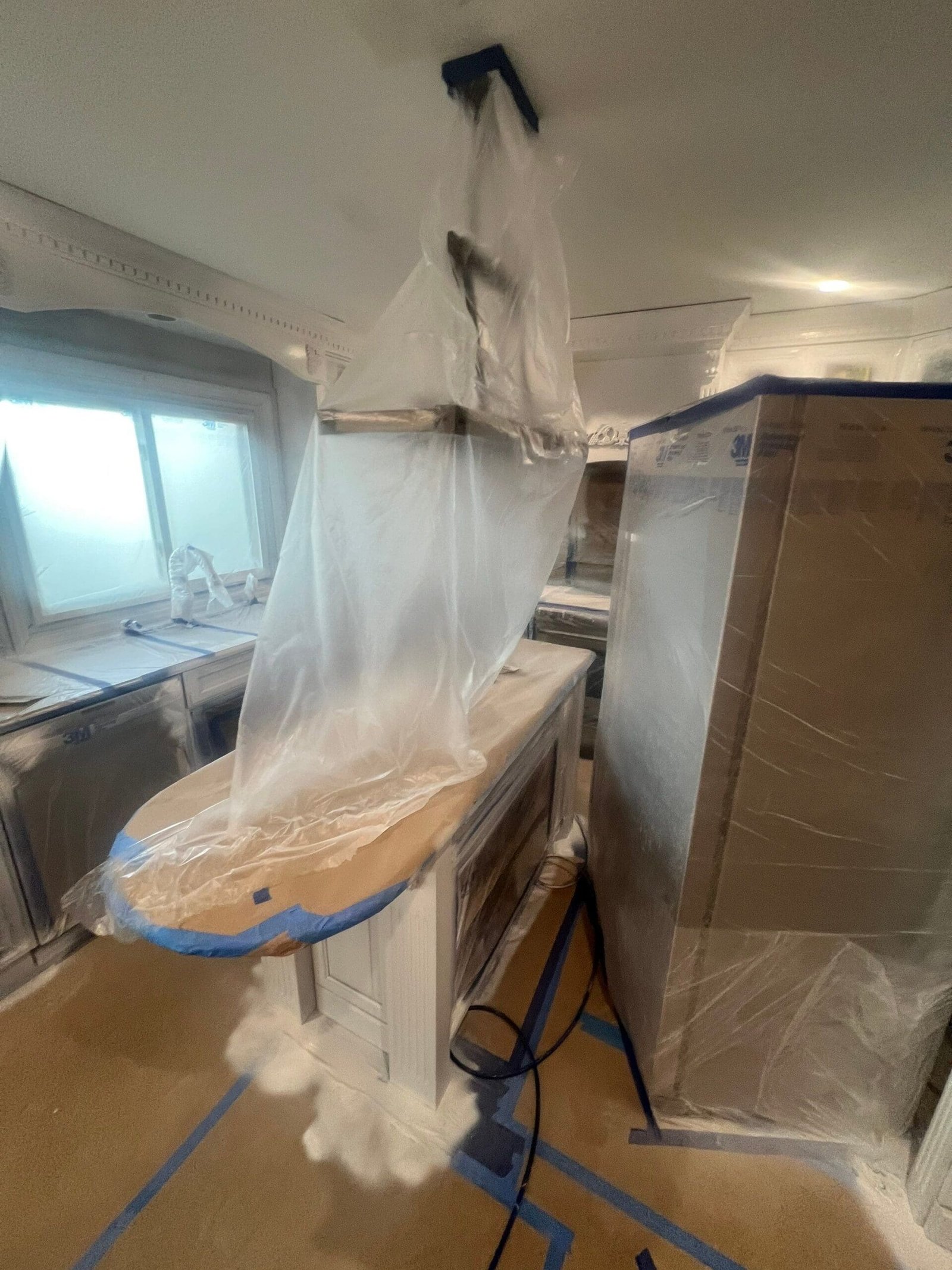 Macomb Kitchen Renovation 9 a kitchen covered in plastic
