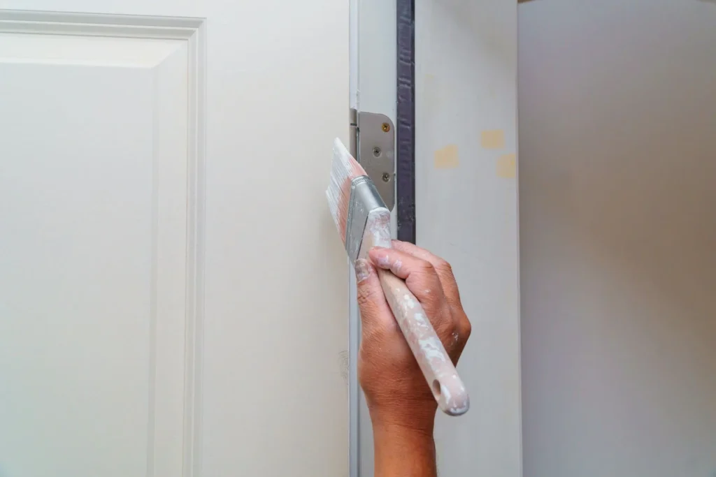 A Comprehensive Guide to Paint Finishes: Making the Right Choice for Your Home 9 a person painting a door