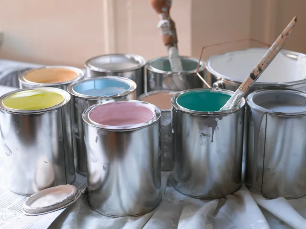 paint cans of paint with paintbrushes