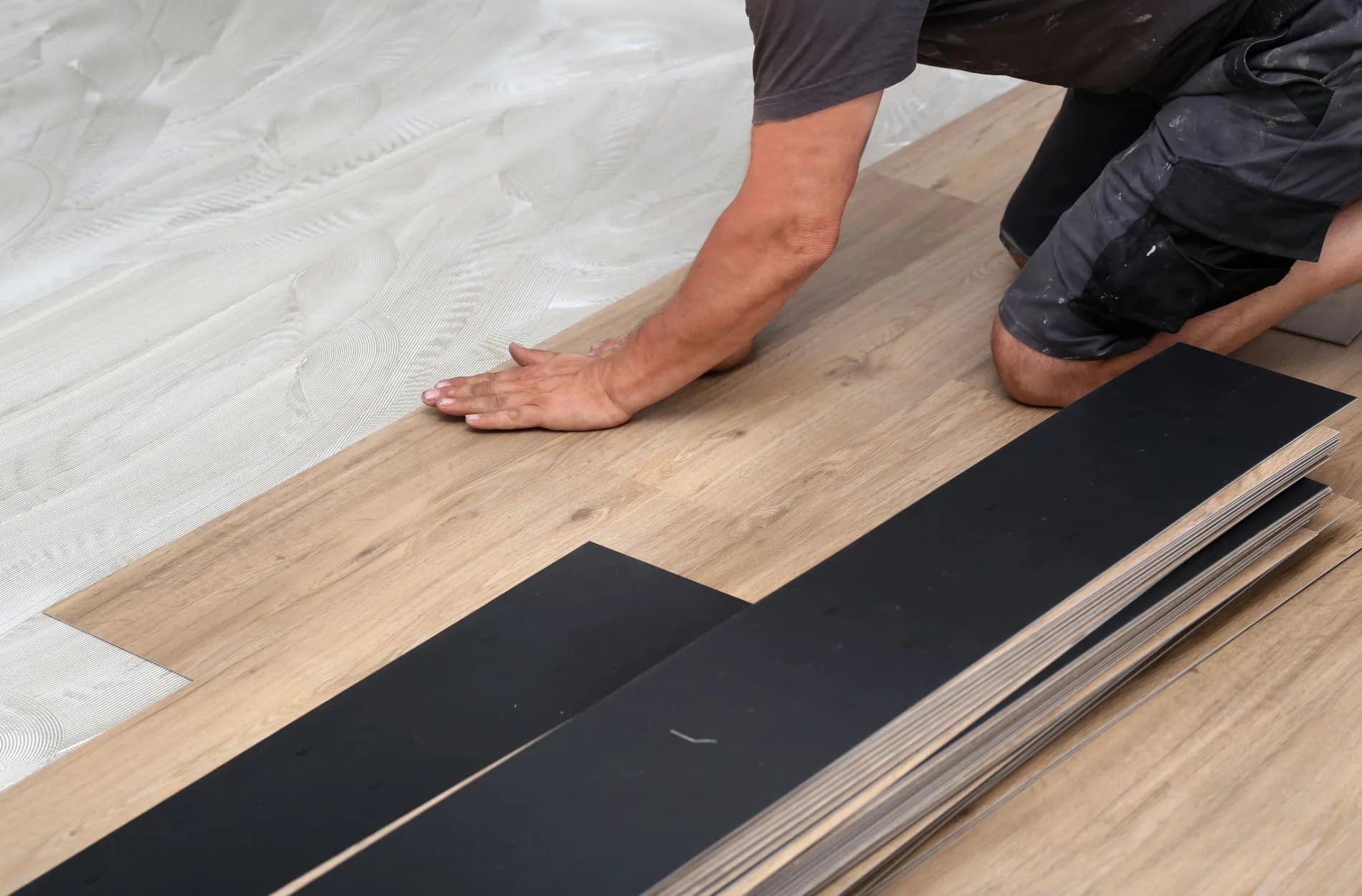 a person installing a wood floor