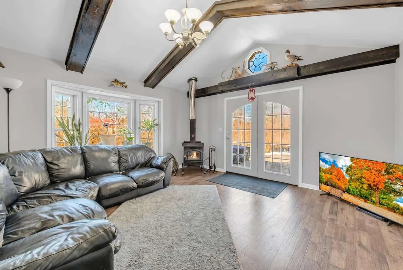 a living room with a leather couch and a fireplace